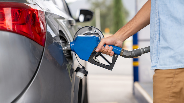 A person refueling their car at a gas stop