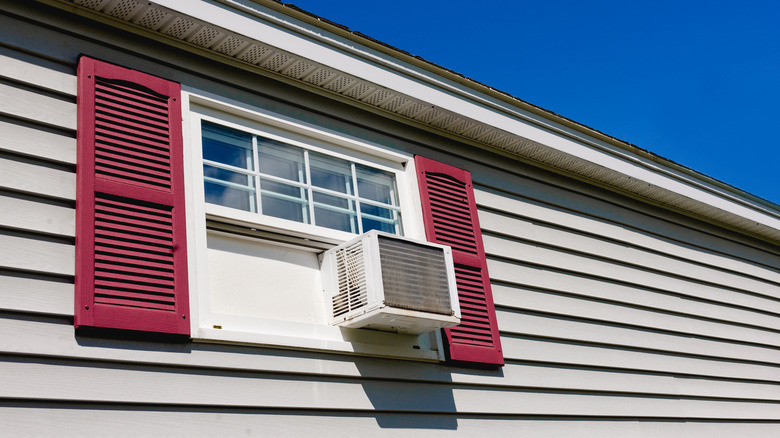 Outside of house with AC filling wide window