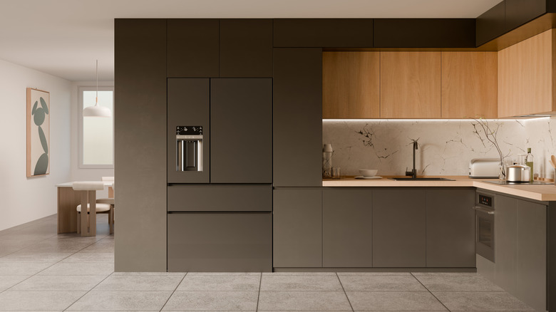 A minimalist kitchen with a built-in fridge.
