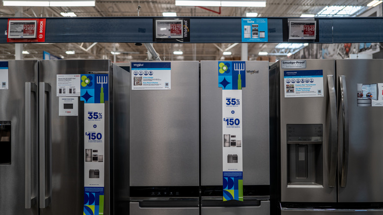 Various fridges for sale in a hardware store.