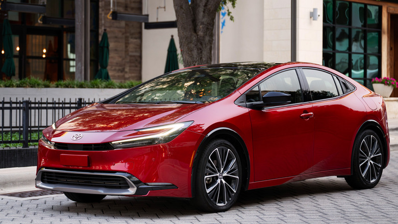 2027 Toyota Prius on urban backdrop, front-left 3/4 view