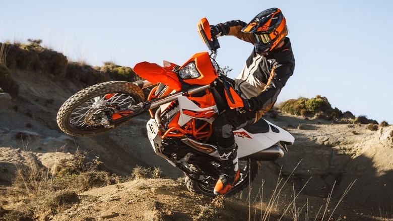 Rider jumping of dune in KTM 690 Enduro R