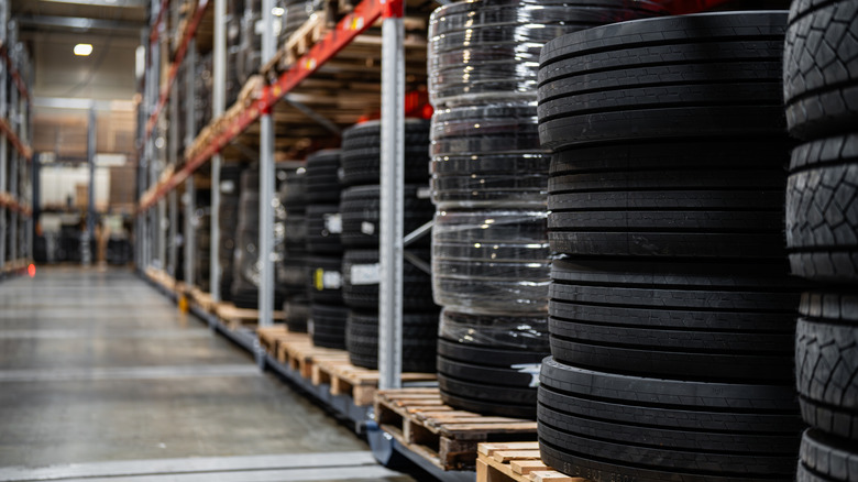 A tire warehouse with plenty of new tires stacked and stored.