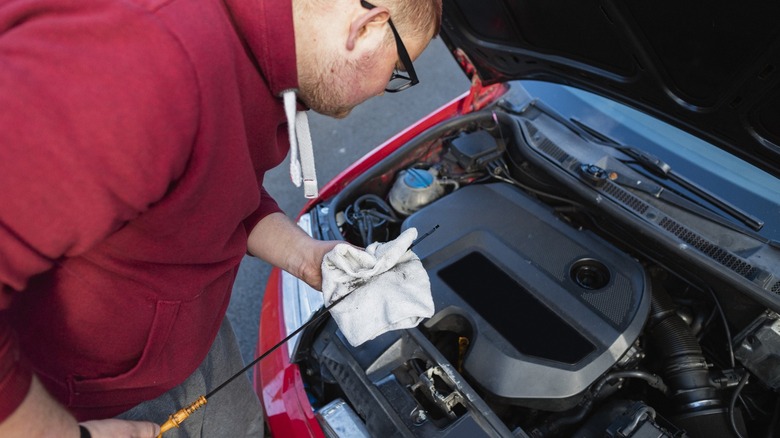 person checking their oil