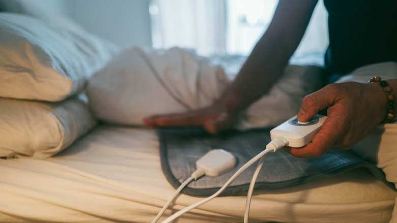 person using electric blanket controller