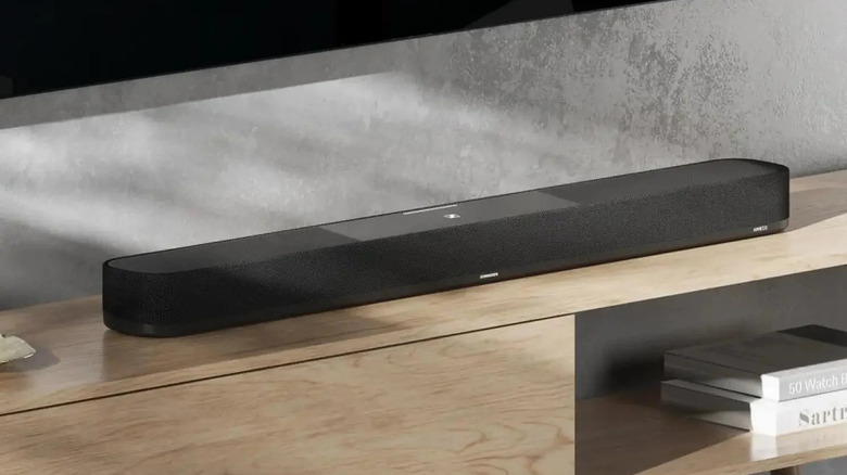 An Ambeo Soundbar Plus in a living room.