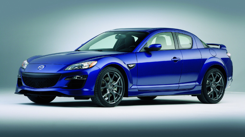 The final iteration of the Mazda RX-8 in blue, front 3/4 view, studio shot
