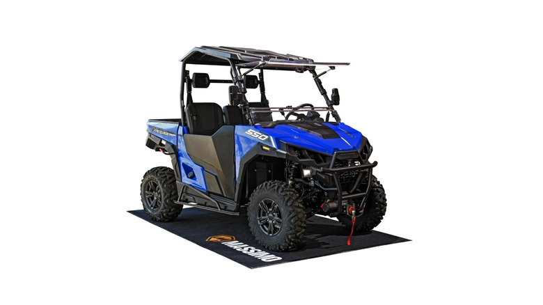 Massimo UTV parked on a garage floor mat pictured against a white background