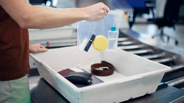 putting personal items in airport security bin