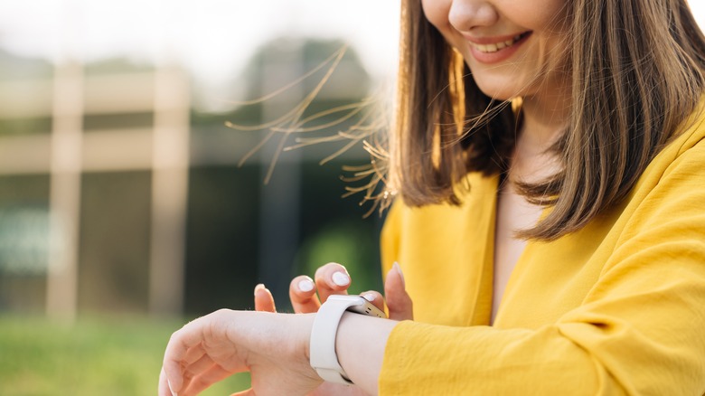 person smiling at smart watch