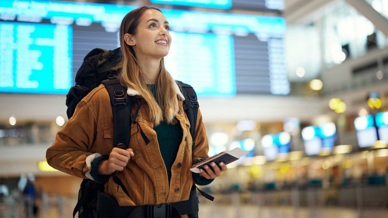 smiling person in airport terminal