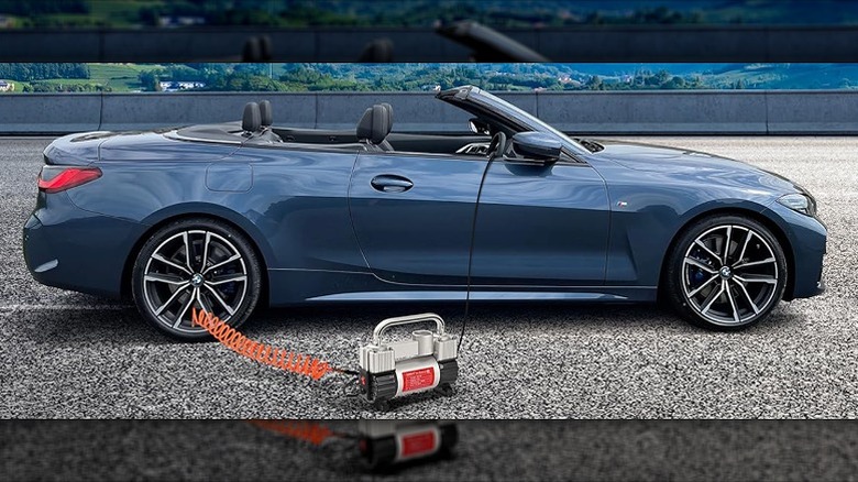Tire inflator connected to a tire of a blue sports car.