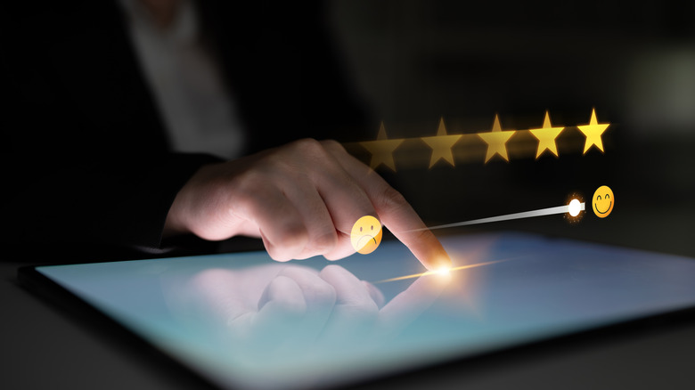 Holographic image of ratings and reviews with happy and sad emojis.
