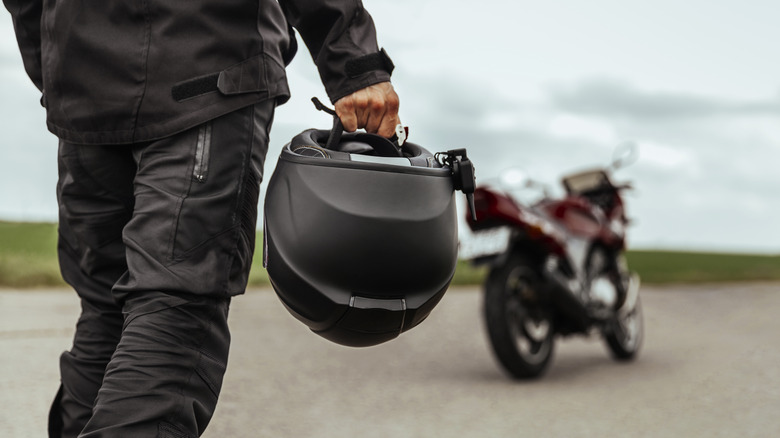 man walking to motorcycle