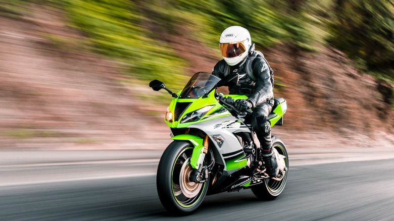 Rider on motorcycle driving on road