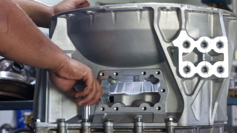 Mechanic working on transmission case