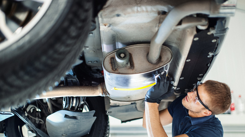 Technician works on exhaust system