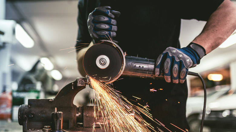 worker cutting steel with angle grinder