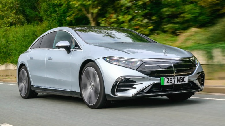Mercedes-Benz EQS450+ Sedan driving with greenery in the background