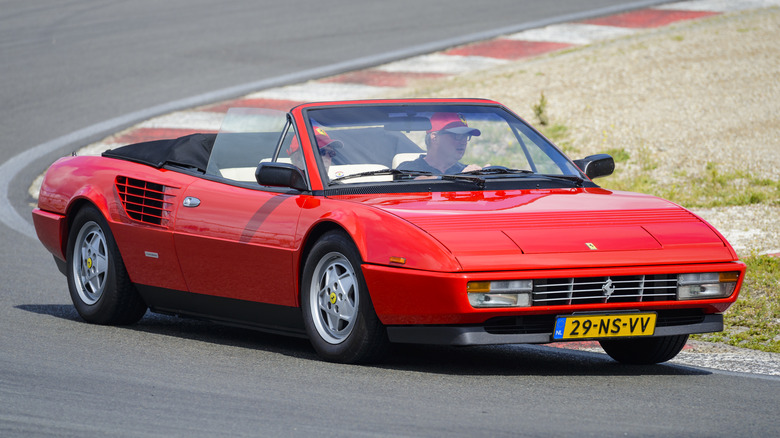 A red Ferrari Mondial being driven on a track.