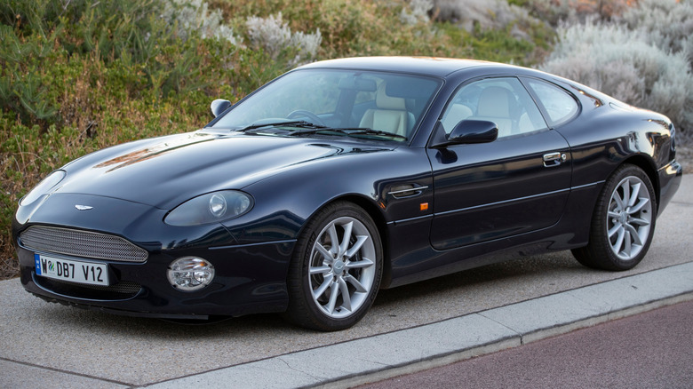 A blue Aston Martin DB7 V12 Vantage parked.