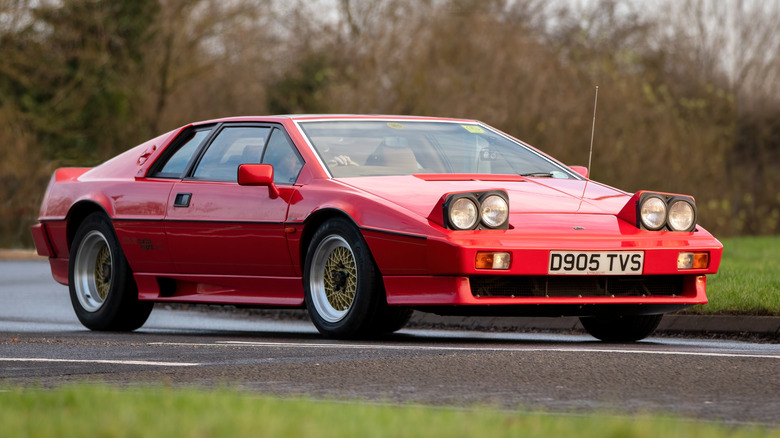 A red Lotus Esprit Turbo SE being driven down a road.