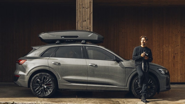 man next to car with roof box