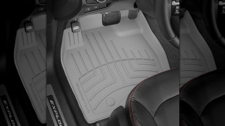 A gray WeatherTech floor in the driver's side footwell of a Ford Explorer
