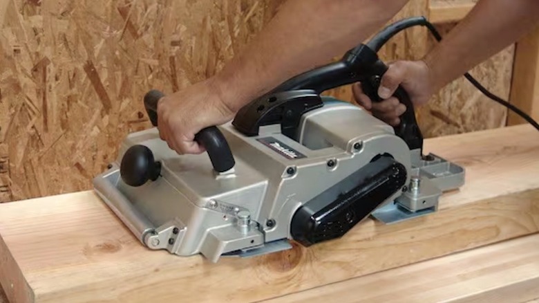 Person using Makita Planer