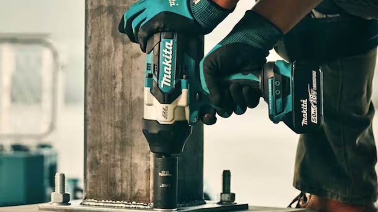 Person using Makita Drive Impact Wrench
