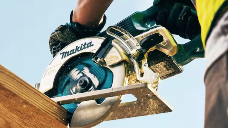 Person using Makita Rear Handle Circular Saw