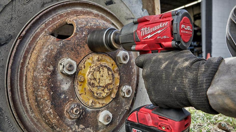 A Milwaukee Fuel Impact Wrench used on a car wheel.