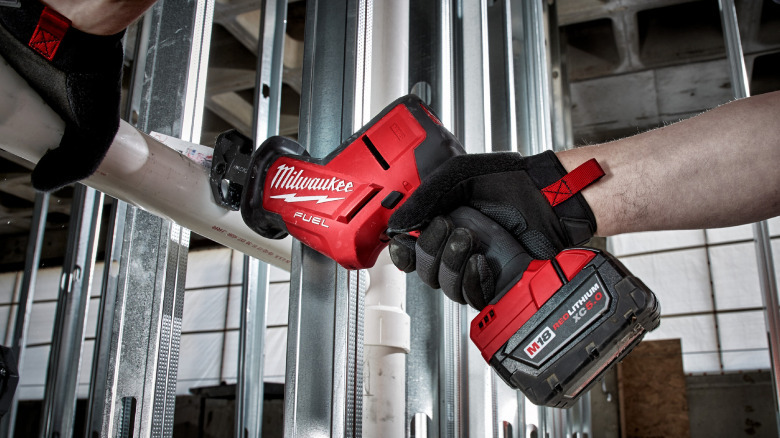 A Milwaukee Sawzall cutting a plastic tube.