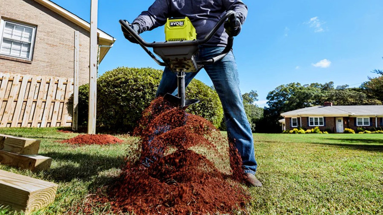Ryobi 40V HP earth auger churning up dirt