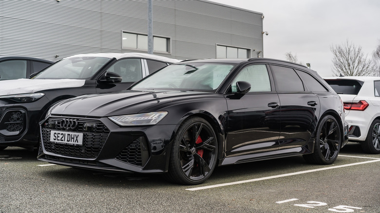 A black Audi RS6 Performance Avant parked near other Audi's.