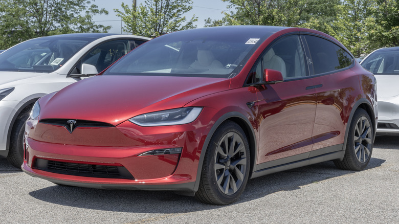 A red Tesla Model X Plaid parked.