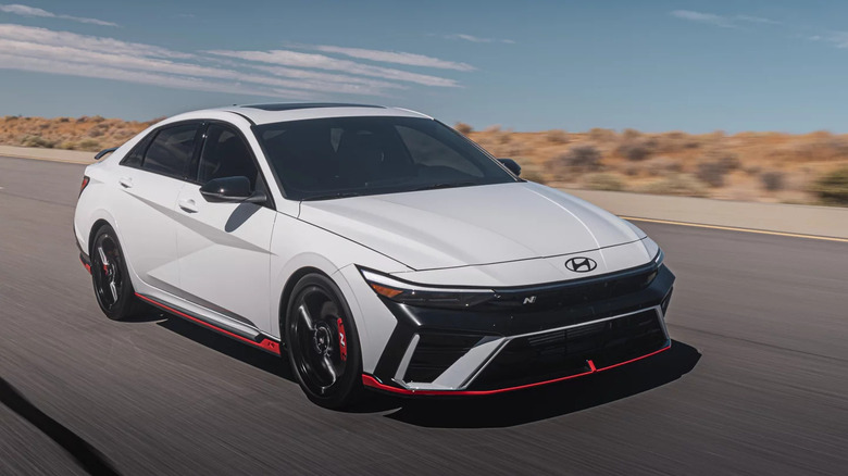 2026 Hyundai Elantra N Line driving on racetrack, front-right 3/4 view