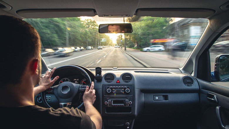 man driving fast along road