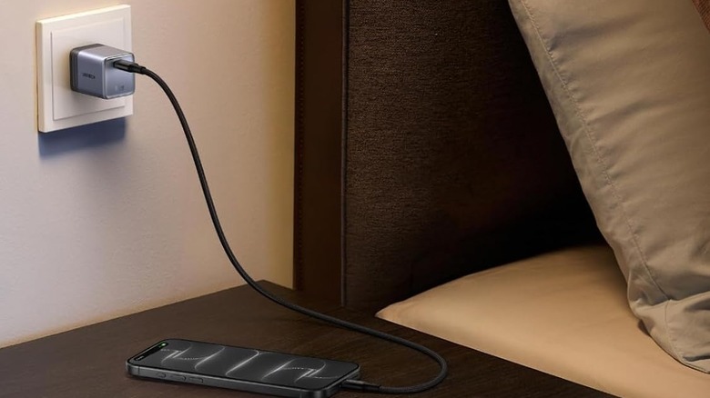 A UGREEN Nexode Air 65W charger plugged into a socket