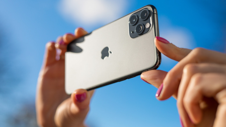 person taking pictures with iPhone