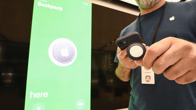 man holding airtag