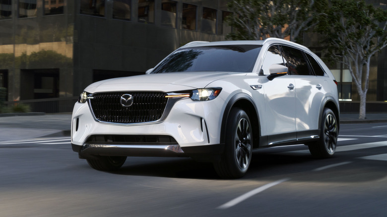 Mazda CX-90 cornering at speed front 4/3 view