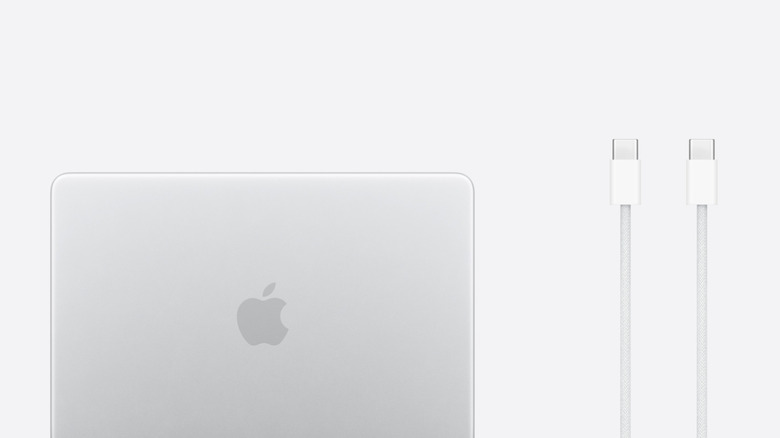 A MacBook Neo next to its included charging cable, white background
