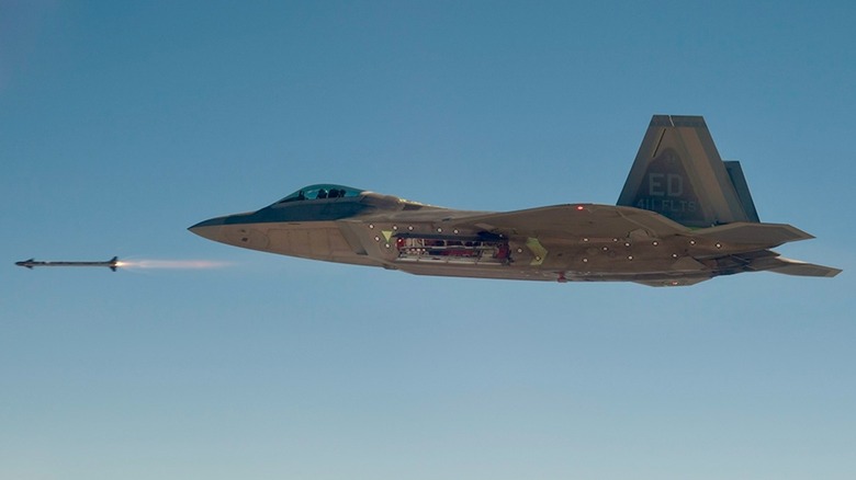 An F-22 fire a missile over clear skies