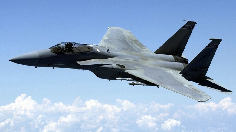 An F-15A flying over cloudy skies