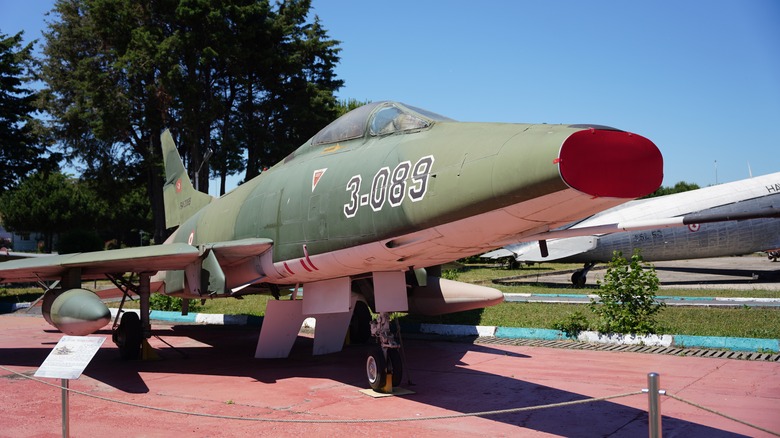 A Turkish Air Force North American F-100C Super Sabre in an outdoor museum setting on a sunny day.
