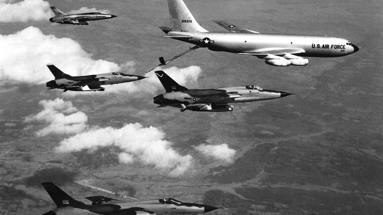 A Boeing KC-135 Stratotanker aircraft refuels a quartet of Republic F-105D Thunderchief jets on their way to a North Vietnamese target.