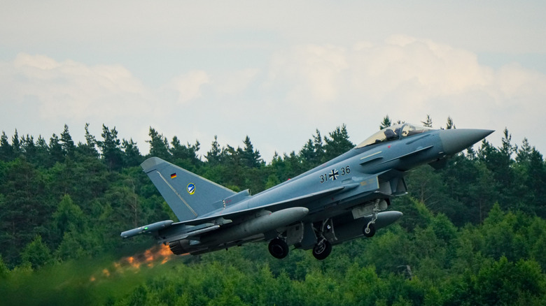German Air Force Eurofighter Typhoon at takeoff, its landing gear folding in