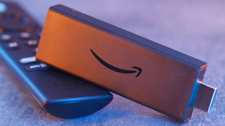 A close up shot of a Fire TV stick with its original remote