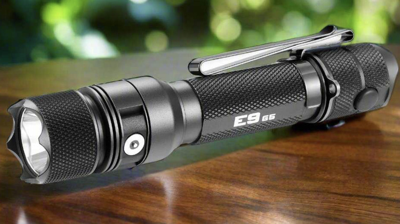 Close-up of a small, tactical Powertac flashlight